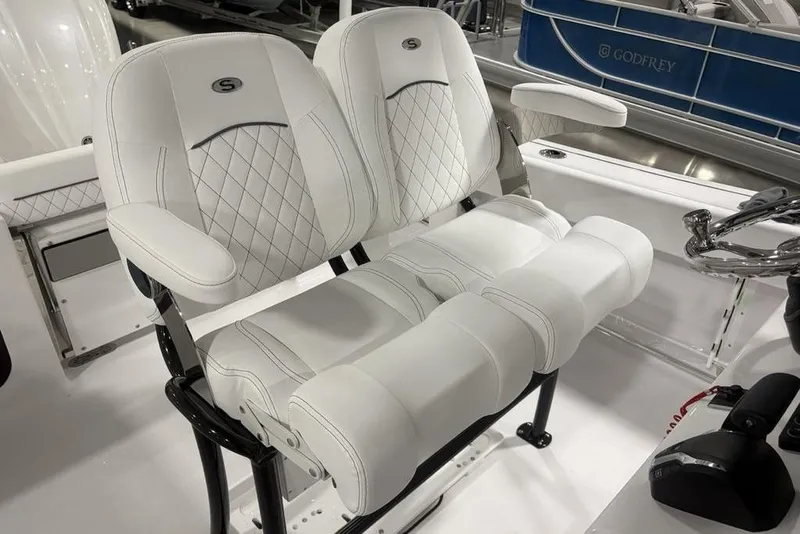 Slide: The Image of 2026 Sportsman Open 232 Center Console boat with luxurious white seating and armrests. - 20