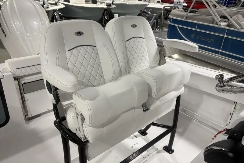 Slide: The Image of 2026 Sportsman Open 232 Center Console boat with luxurious white seating and armrests. - 21