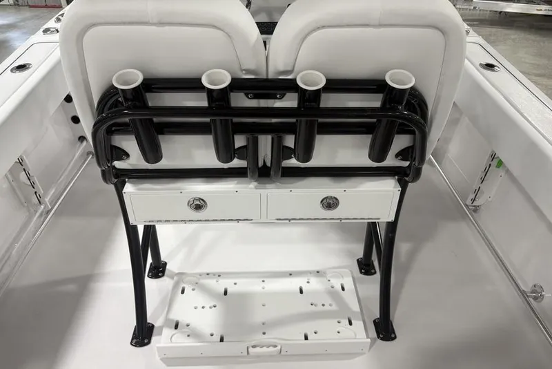 Slide: The Image of 2026 Sportsman Open 232 Center Console boat interior with rod holders and storage drawers. - 23