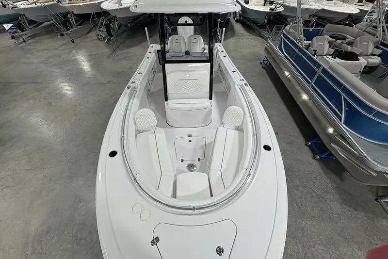 Slide: The Image of 2026 Sportsman Open 232 Center Console boat in showroom, featuring spacious seating and modern design. - 24