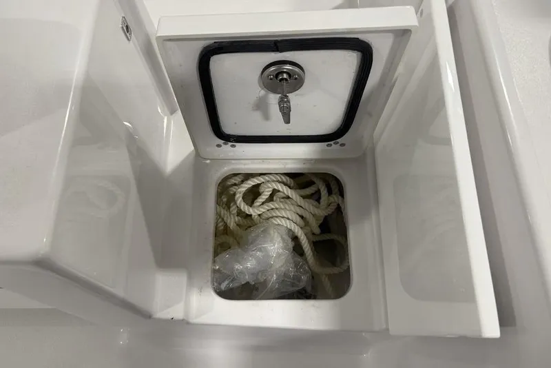 Slide: The Image of Storage compartment with rope in 2026 Sportsman Open 232 Center Console boat. - 27