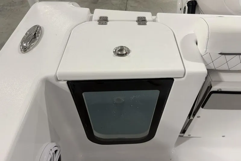 Slide: The Image of 2026 Sportsman Open 232 Center Console boat interior detail with storage compartment. - 31