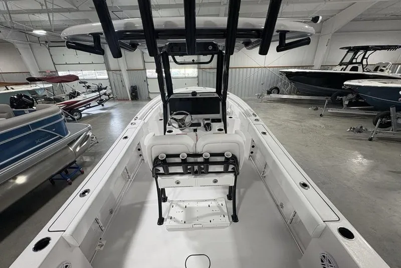 Slide: The Image of 2026 Sportsman Open 232 Center Console boat in showroom, featuring sleek design and modern amenities. - 32