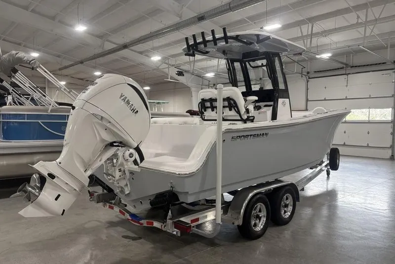 Slide: The Image of 2026 Sportsman Open 232 Center Console boat in a showroom, featuring a Yamaha outboard motor. - 4