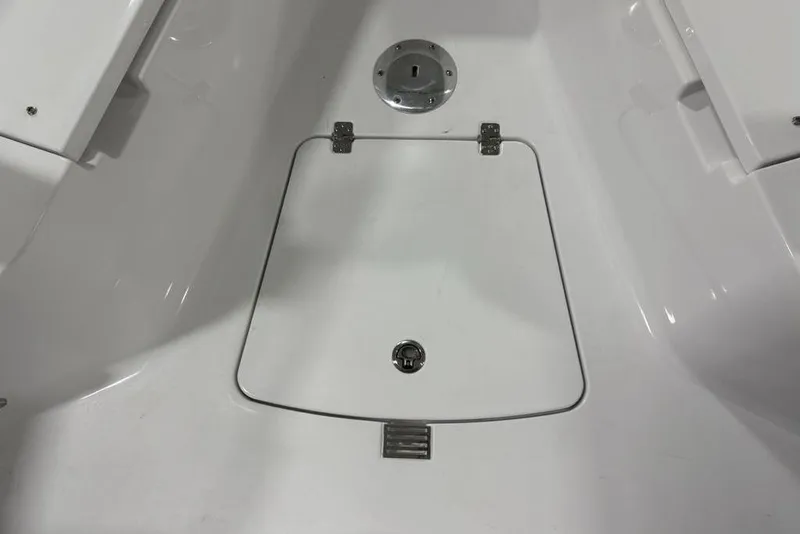 Slide: The Image of 2026 Sportsman Open 232 Center Console boat deck with storage hatch. - 9