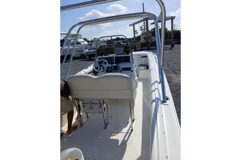 Slide: The Image of 1999 Wellcraft Scarab 302 Sport cabin interior with cushioned seating and storage. - 14