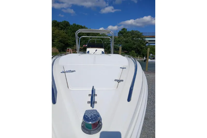 Slide: The Image of 1999 Wellcraft 302 Scarab Sport boat docked under a clear blue sky. - 27