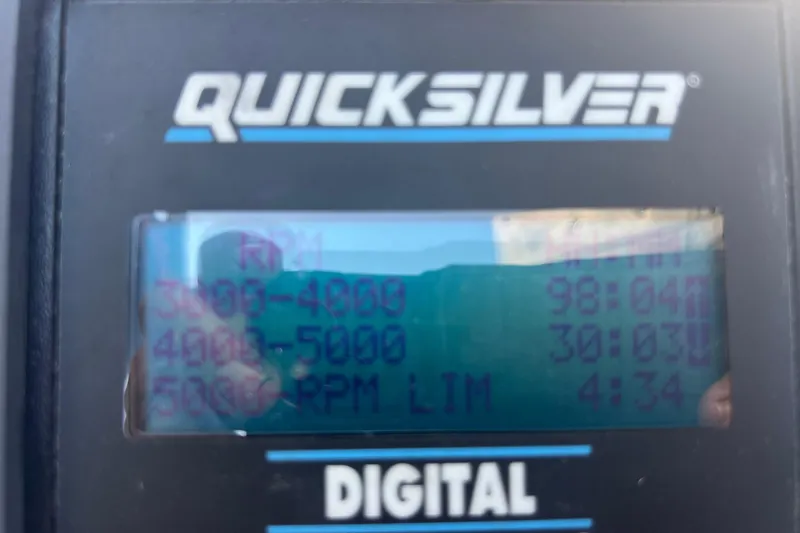 Slide: The Image of Digital display showing RPM data on a Quicksilver device for a 1999 Wellcraft 302 Scarab Sport. - 36
