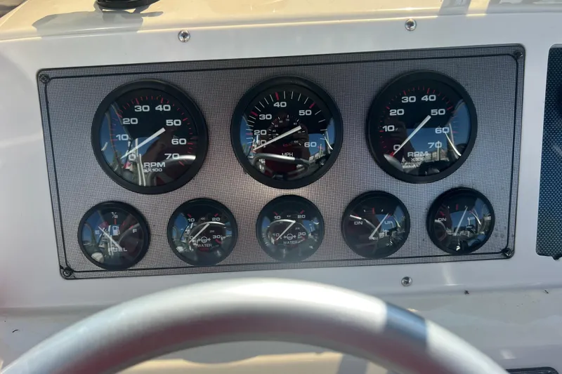 Slide: The Image of Dashboard of a 1999 Wellcraft 302 Scarab Sport boat with various gauges. - 43