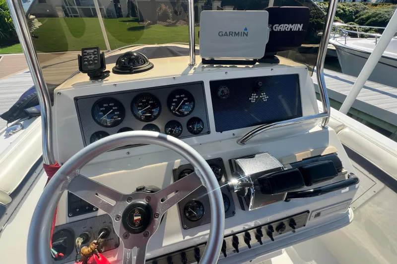 Slide: The Image of 1999 Wellcraft 302 Scarab Sport dashboard with Garmin navigation and control instruments. - 44