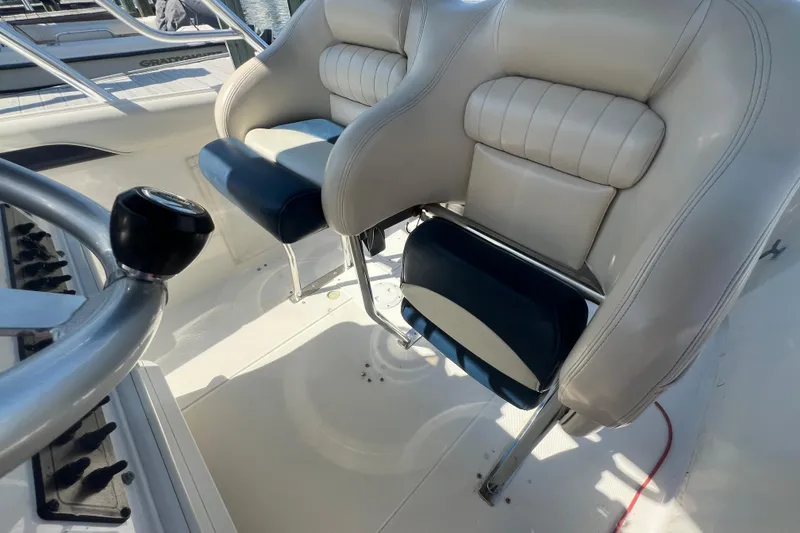 Slide: The Image of Interior of 1999 Wellcraft 302 Scarab Sport boat with cushioned seating. - 50