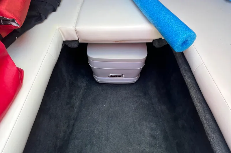 Slide: The Image of Interior of 1999 Wellcraft 302 Scarab Sport with storage area and marine equipment. - 52