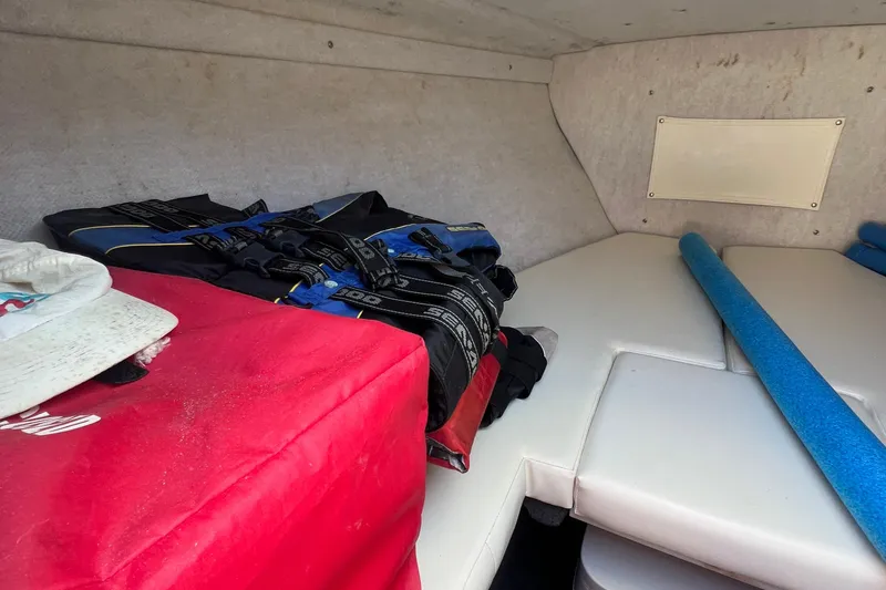 Slide: The Image of Interior of 1999 Wellcraft 302 Scarab Sport boat with life jackets and pool noodle. - 54
