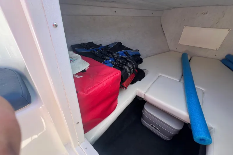 Slide: The Image of Interior cabin of 1999 Wellcraft 302 Scarab Sport with life jackets and pool noodle. - 57