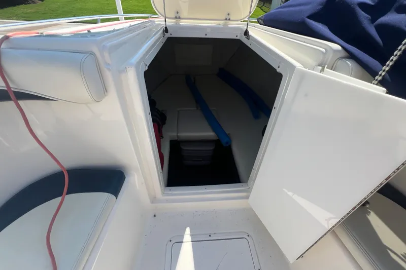 Slide: The Image of 1999 Wellcraft 302 Scarab Sport cabin interior with open door, showcasing seating and storage. - 58