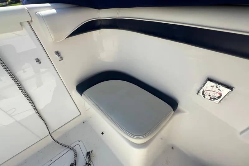 Slide: The Image of Interior seating of 1999 Wellcraft 302 Scarab Sport boat, featuring white and navy upholstery. - 60