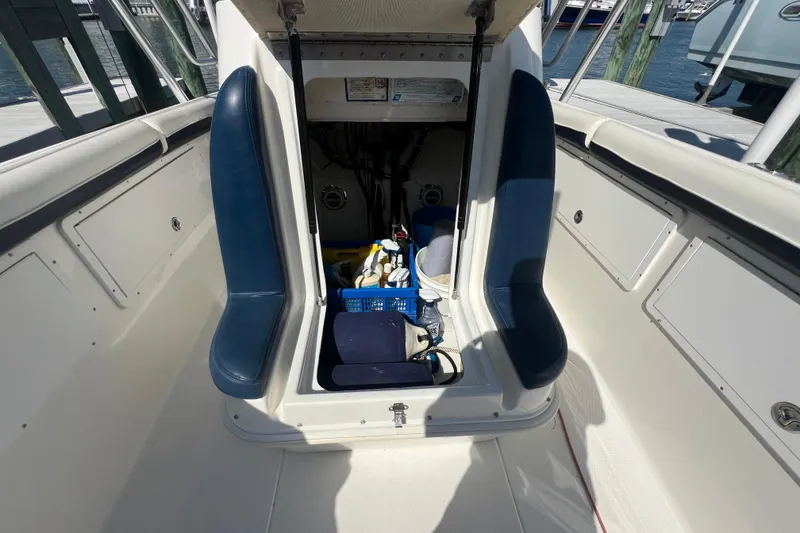 Slide: The Image of 1999 Wellcraft 302 Scarab Sport boat interior with storage compartment open. - 62
