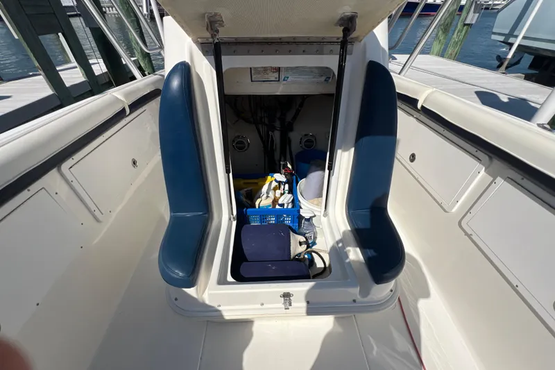 Slide: The Image of 1999 Wellcraft 302 Scarab Sport boat interior with storage compartment open. - 63