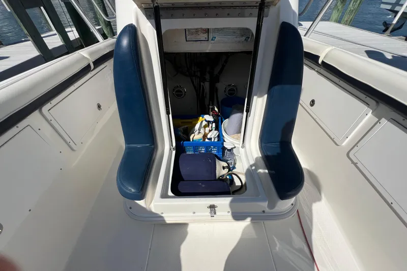 Slide: The Image of Interior of a 1999 Wellcraft 302 Scarab Sport boat with storage compartment open. - 64