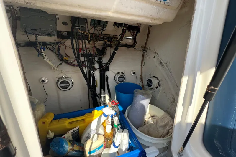 Slide: The Image of Interior view of a 1999 Wellcraft 302 Scarab Sport boat showing storage and wiring. - 66