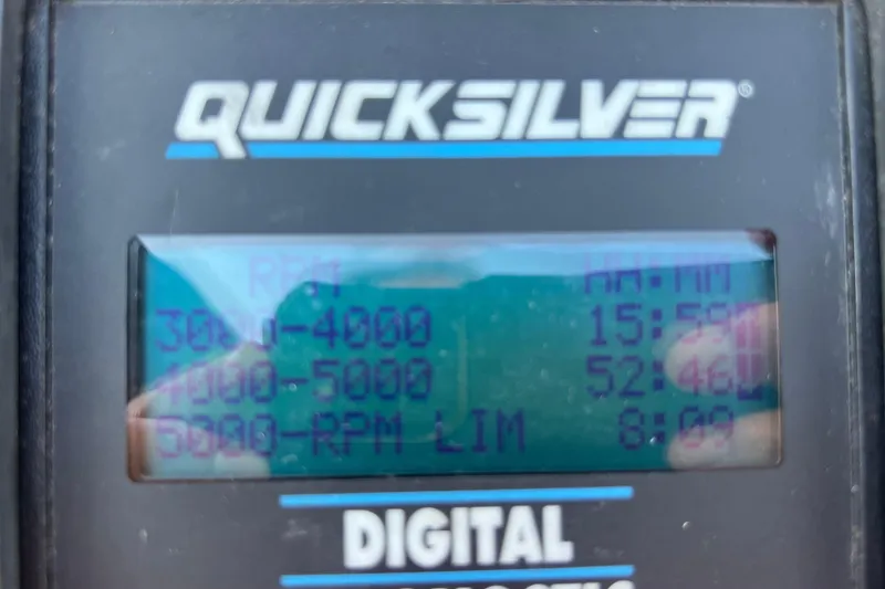 Slide: The Image of Digital display showing RPM data on a Quicksilver device for a 1999 Wellcraft 302 Scarab Sport. - 69