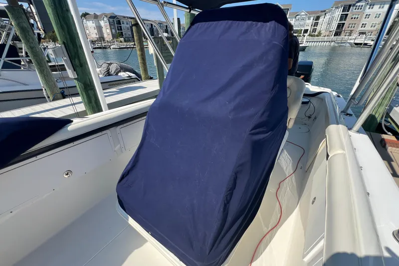 Slide: The Image of 1999 Wellcraft 302 Scarab Sport boat with covered seating, docked in a marina. - 71