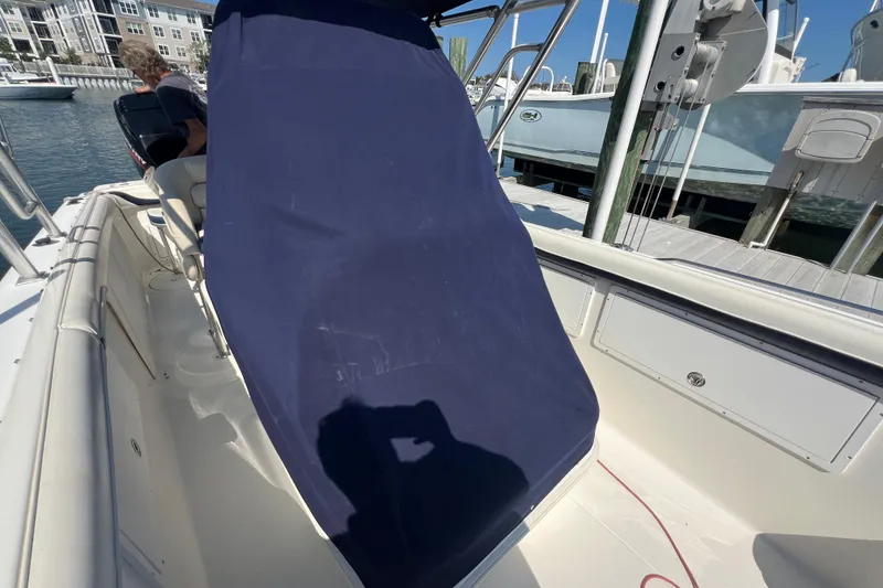 Slide: The Image of 1999 Wellcraft 302 Scarab Sport boat interior with blue cover, docked at marina. - 72