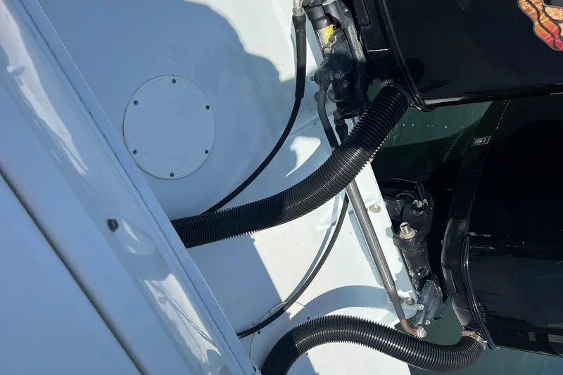 Slide: The Image of 1999 Wellcraft 302 Scarab Sport boat engine compartment with visible cables and components. - 77