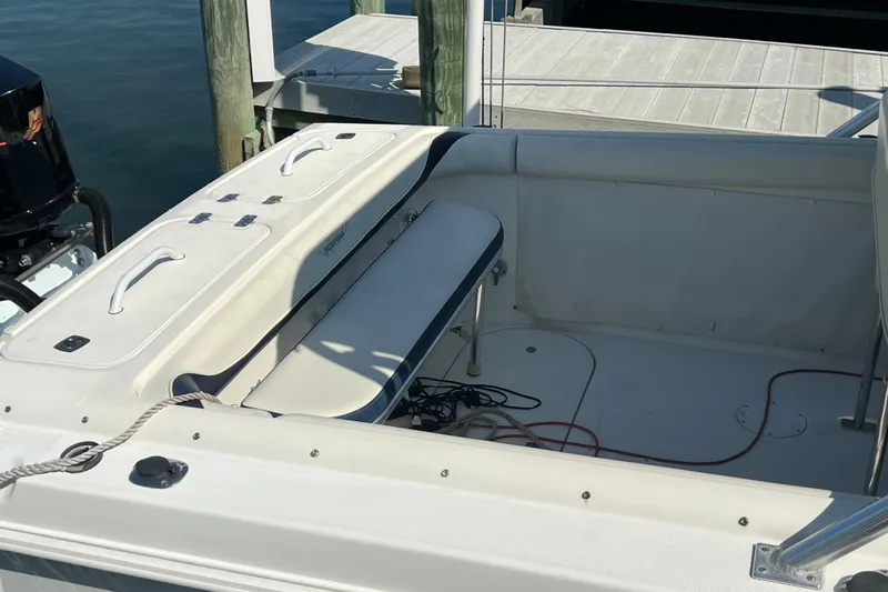 Slide: The Image of 1999 Wellcraft 302 Scarab Sport boat interior with seating and storage compartments. - 82