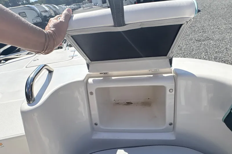 Slide: The Image of Open storage compartment on a 2022 Splendor 239 Sunstar boat, with hand lifting seat. - 20