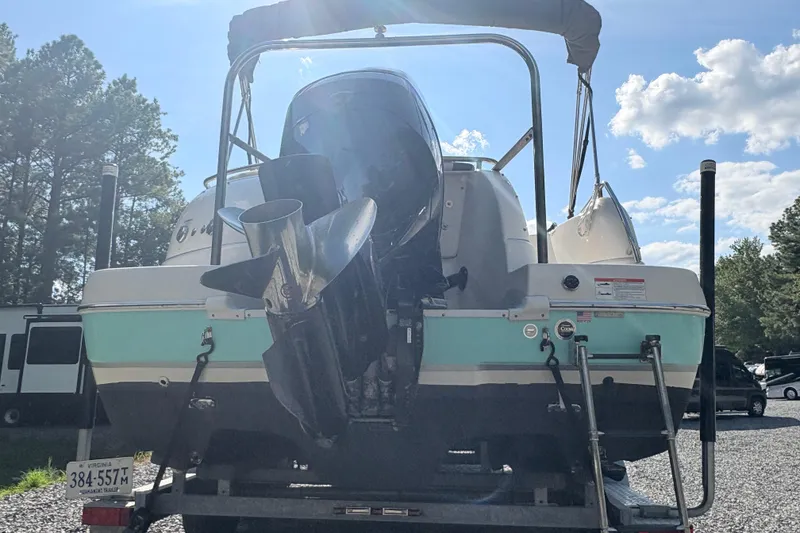 Slide: The Image of 2022 Splendor 239 Sunstar boat with outboard motor, parked on a trailer. - 3