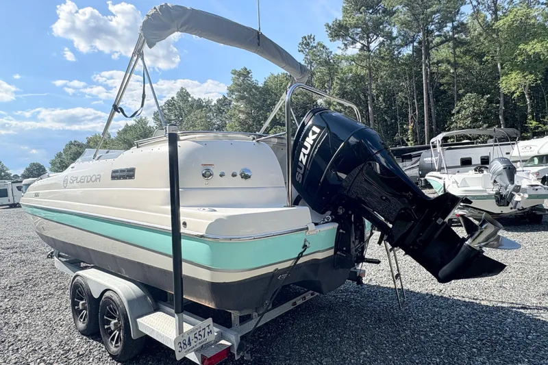 Slide: The Image of 2022 Splendor 239 Sunstar boat with Suzuki outboard motor on trailer, parked outdoors. - 4