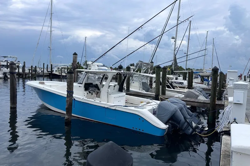 The Image of 2016 Edgewater 370CC boat docked at marina with overcast sky. - 0
