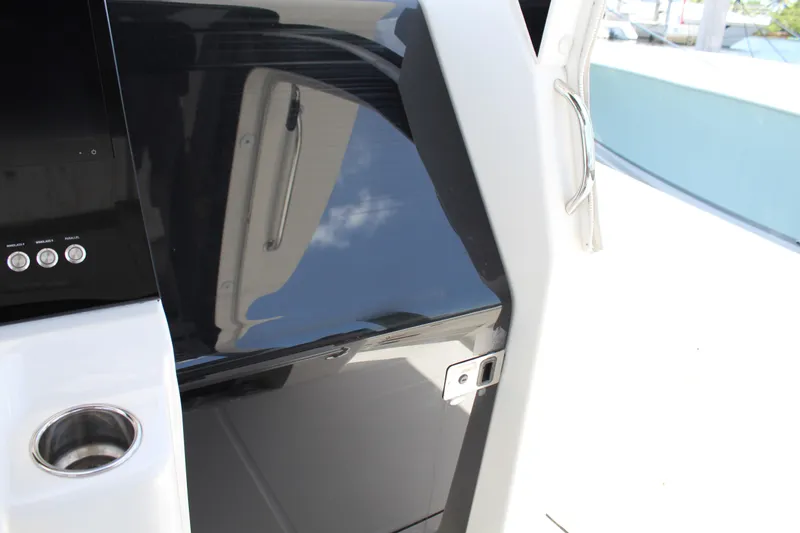 Slide: The Image of Edgewater 370CC 2016 boat console with cup holder and control panel. - 12