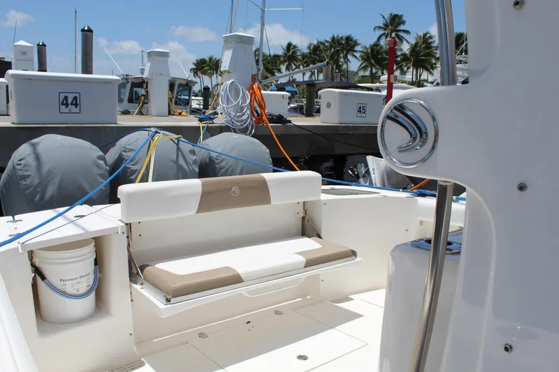 Slide: The Image of 2016 Edgewater 370CC boat interior with seating, docked at marina. - 17