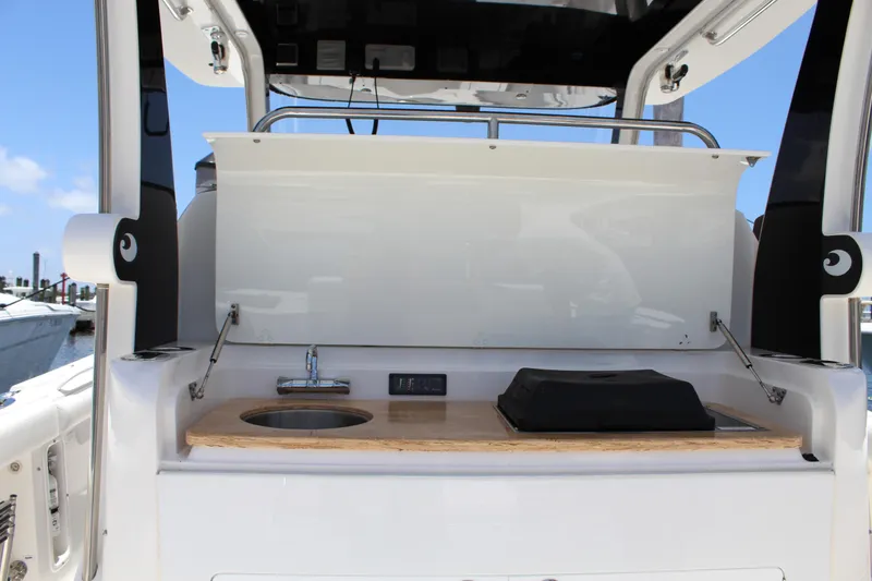 Slide: The Image of 2016 Edgewater 370CC boat interior with sink and counter setup. - 18