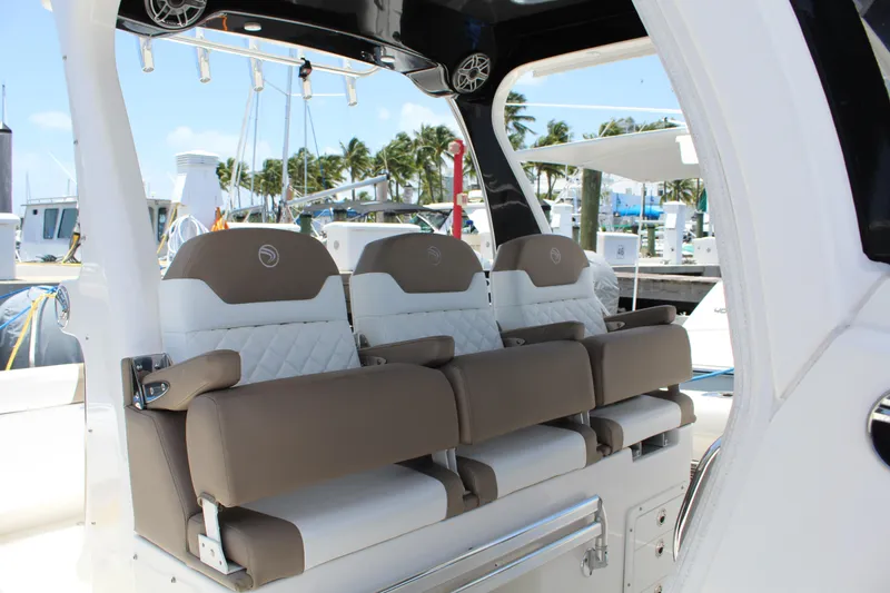 Slide: The Image of Luxury seating on 2016 Edgewater 370CC boat, docked with palm trees in background. - 2