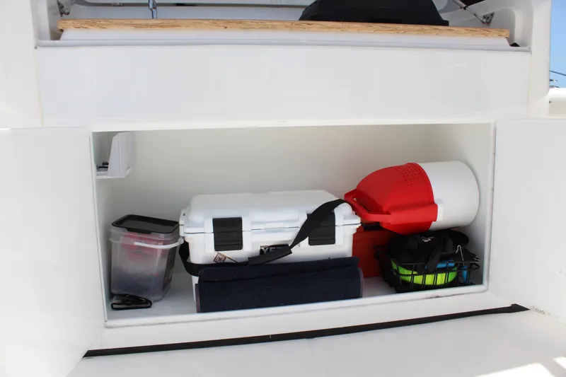 Slide: The Image of Storage compartment in a 2016 Edgewater 370CC boat with various gear and equipment. - 20