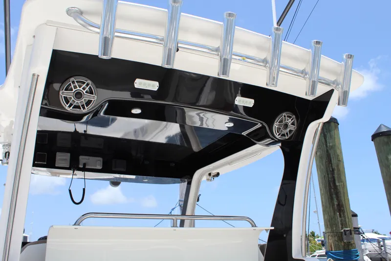 Slide: The Image of 2016 Edgewater 370CC boat with sleek black and white design, featuring speakers and rod holders. - 21