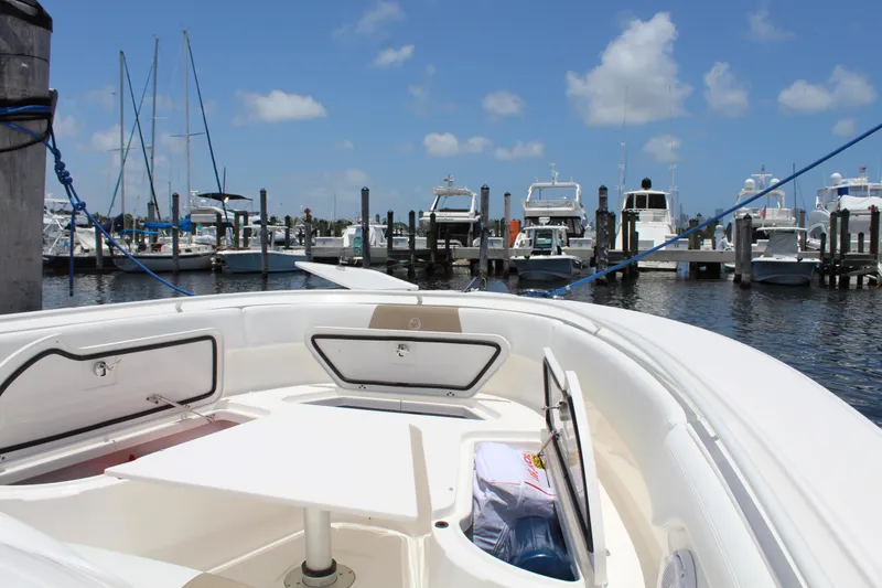 Slide: The Image of 2016 Edgewater 370CC boat docked at marina under clear blue sky. - 25