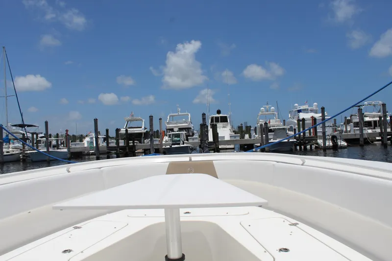 Slide: The Image of 2016 Edgewater 370CC boat docked at marina under clear blue sky. - 26
