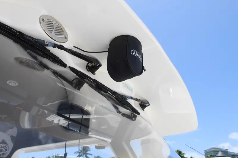 Slide: The Image of 2016 Edgewater 370CC boat with speaker and wiper details under clear blue sky. - 29