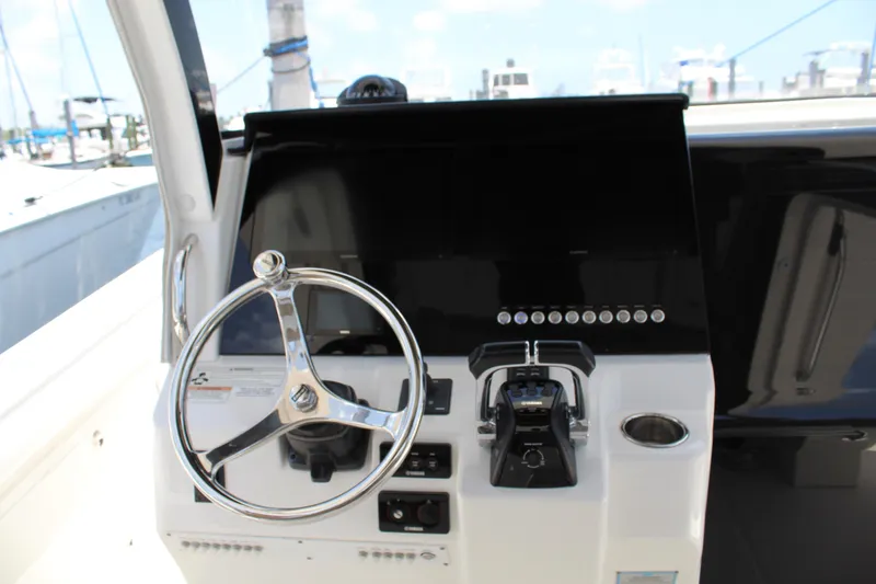 Slide: The Image of Helm of 2016 Edgewater 370CC boat with steering wheel and controls. - 3