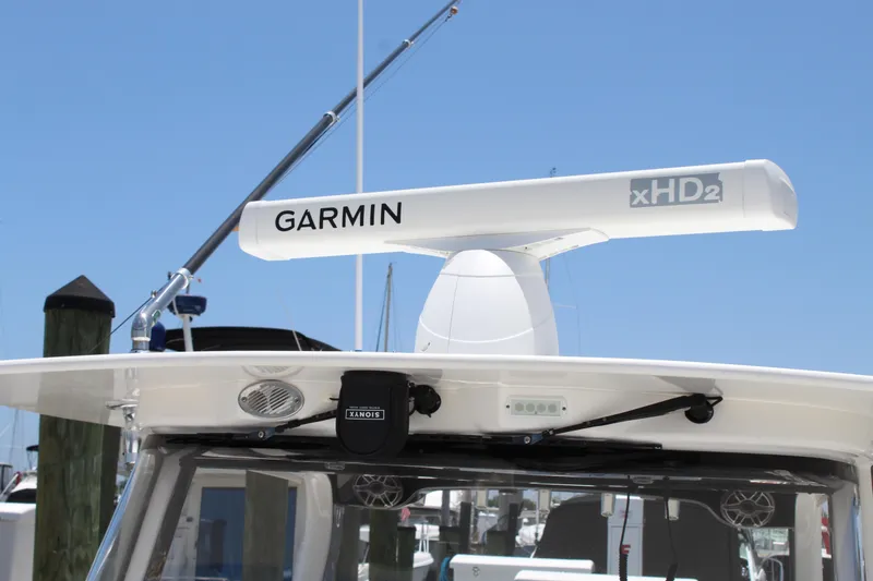 Slide: The Image of Edgewater 370CC 2016 boat with Garmin xHD2 radar system under clear blue sky. - 30