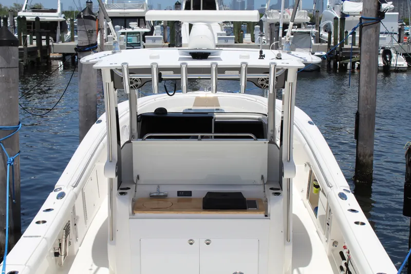 Slide: The Image of 2016 Edgewater 370CC boat docked at marina, featuring spacious deck and modern amenities. - 33