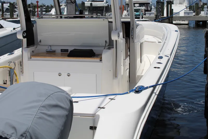 Slide: The Image of 2016 Edgewater 370CC boat docked, showcasing sleek design and spacious deck. - 34