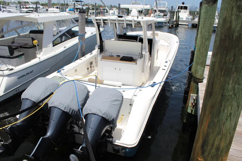 Slide: The Image of 2016 Edgewater 370CC boat docked with triple outboard engines, marina background. - 36