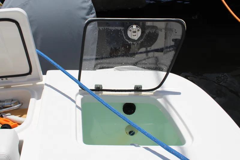 Slide: The Image of Open hatch on 2016 Edgewater 370CC boat with blue rope and water inside. - 39