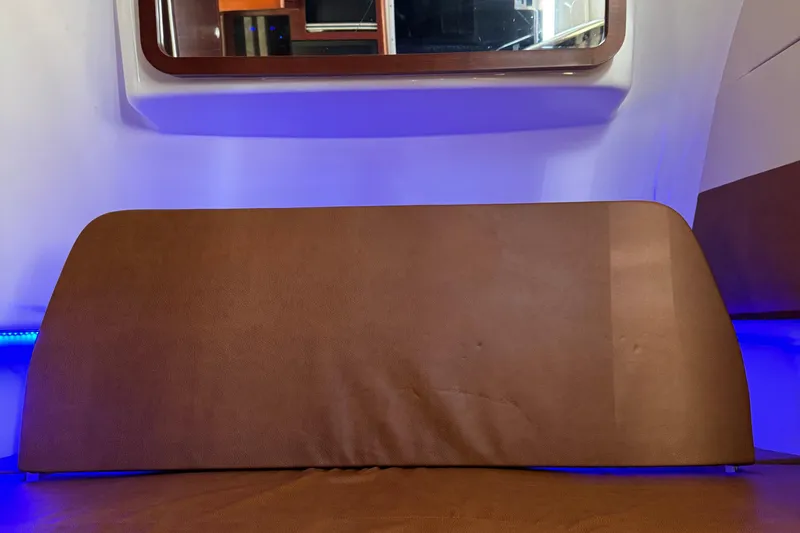 Slide: The Image of Interior of 2016 Edgewater 370CC boat with brown seating and blue ambient lighting. - 41