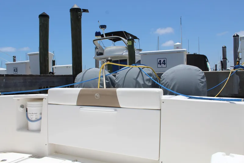 Slide: The Image of 2016 Edgewater 370CC boat docked at marina with blue skies. - 6